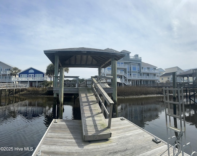 dock area with a gazebo and a water view