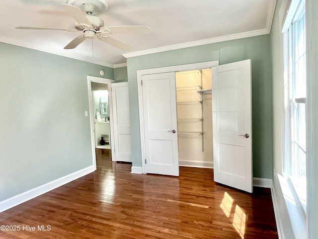 102 N 25th St, Wilmington, NC 28405 - unfurnished bedroom featuring multiple windows, a closet, wood finished floors, and crown molding