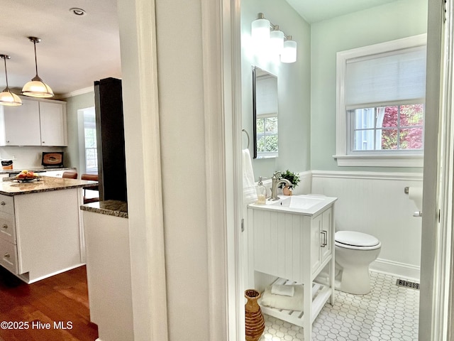 102 N 25th St, Wilmington, NC 28405 - bathroom featuring vanity, toilet, wainscoting, and ornamental molding