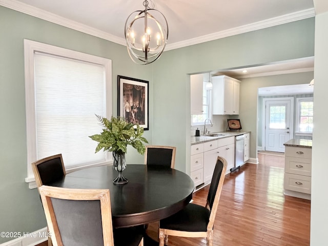 102 N 25th St, Wilmington, NC 28405 - dining area featuring crown molding, a chandelier, and light wood-type flooring