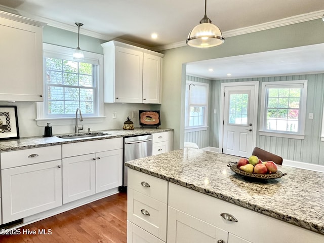 102 N 25th St, Wilmington, NC 28405 - kitchen featuring a sink, stainless steel dishwasher, crown molding, wood finished floors, and white cabinets