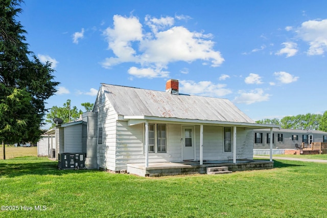 5635 Mckendree Church Rd, Tarboro, NC 27886 - back of property featuring a yard, metal roof, covered porch, and a chimney