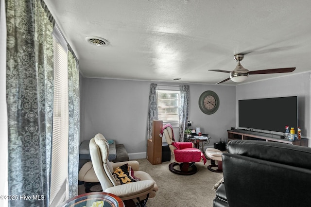 5635 Mckendree Church Rd, Tarboro, NC 27886 - living room featuring a textured ceiling, a ceiling fan, visible vents, carpet floors, and baseboards