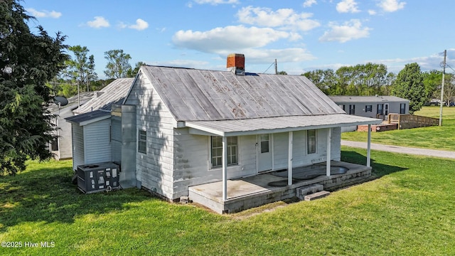 5635 Mckendree Church Rd, Tarboro, NC 27886 - back of house featuring cooling unit, a chimney, and a lawn