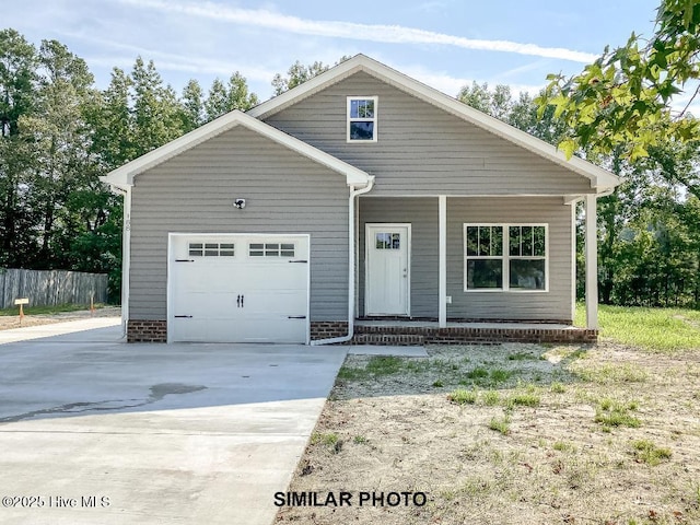 view of front of home featuring driveway, covered porch, a garage, and fence