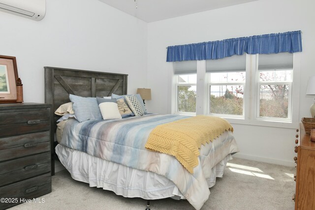 carpeted bedroom with a wall unit AC and baseboards