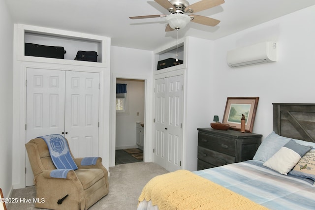 bedroom featuring carpet floors, ceiling fan, a wall unit AC, and two closets