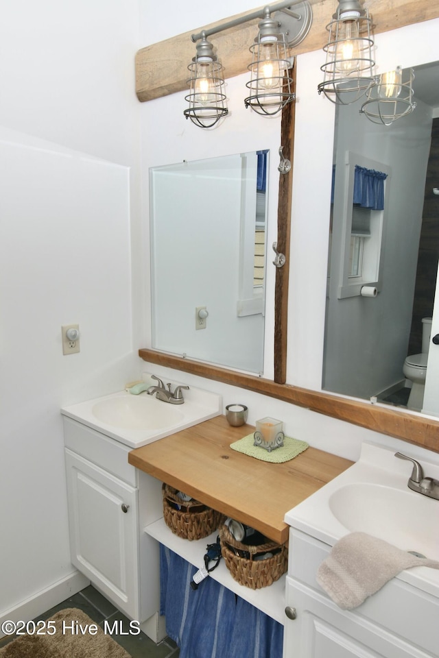 bathroom featuring toilet and vanity