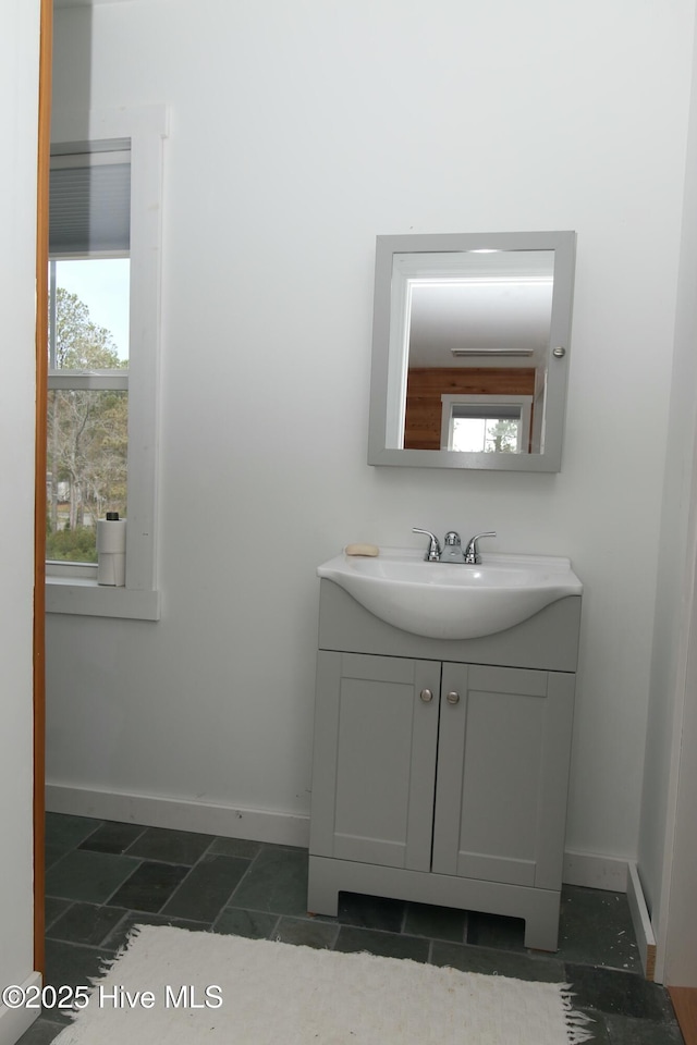 bathroom with baseboards and vanity