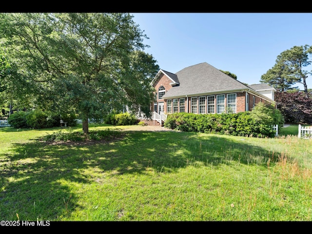4404 Gauntlet Dr SE, Southport, NC 28461 - view of front facade with brick siding and a front yard