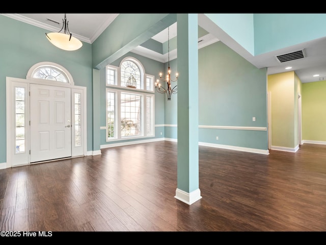 4404 Gauntlet Dr SE, Southport, NC 28461 - foyer entrance featuring a chandelier, baseboards, wood finished floors, crown molding, and a towering ceiling