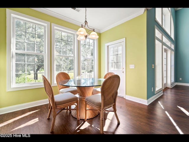 4404 Gauntlet Dr SE, Southport, NC 28461 - dining room featuring healthy amount of natural light, crown molding, dark wood-style floors, and baseboards