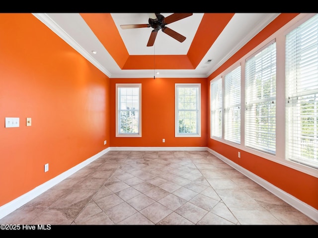 4404 Gauntlet Dr SE, Southport, NC 28461 - spare room with a ceiling fan, a raised ceiling, baseboards, and crown molding