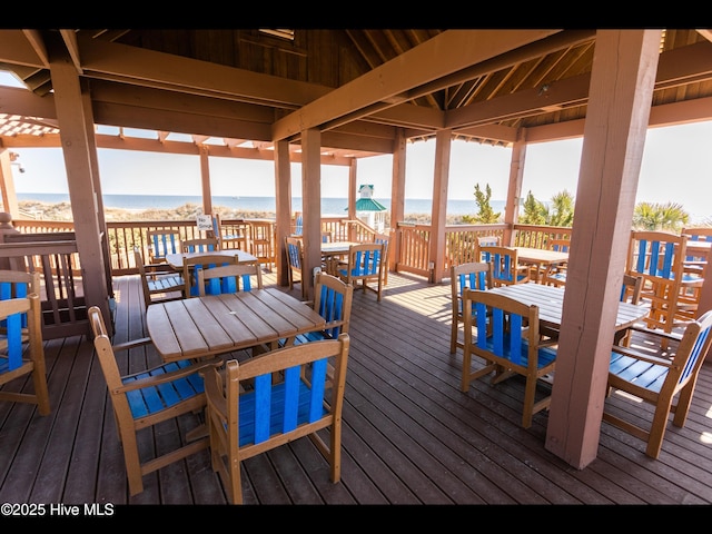 4404 Gauntlet Dr SE, Southport, NC 28461 - wooden deck featuring outdoor dining area and view of water and beach