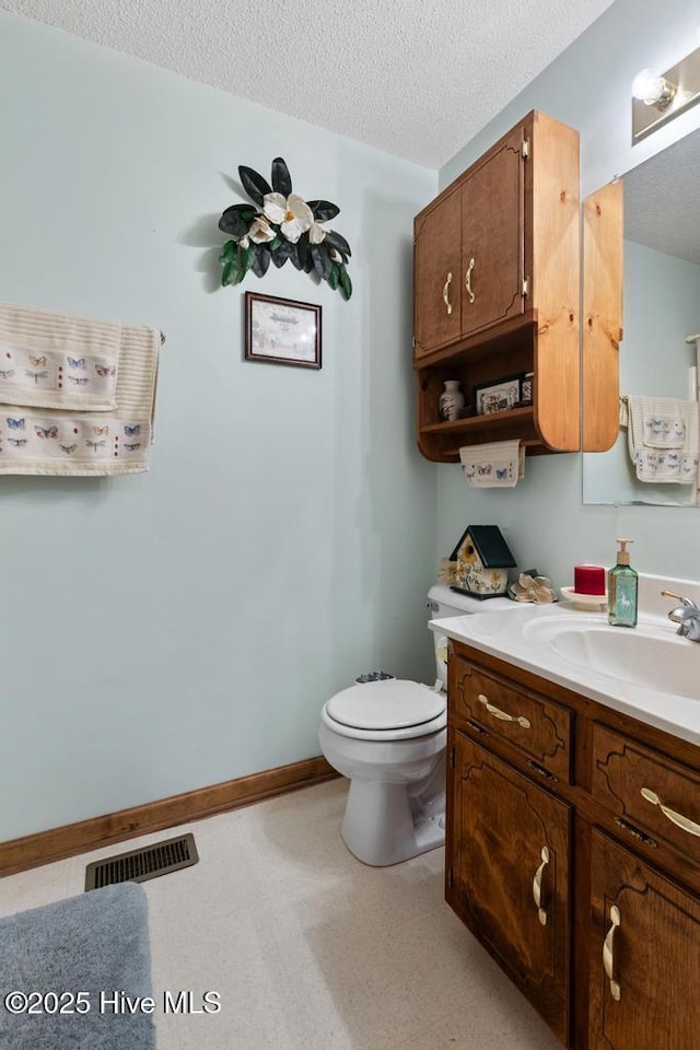 201 Cantle Ct, Jacksonville, NC 28540 - bathroom featuring tile patterned floors, visible vents, toilet, vanity, and a textured ceiling