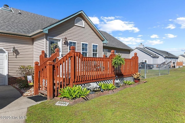201 Cantle Ct, Jacksonville, NC 28540 - back of property featuring fence, a wooden deck, roof with shingles, and a yard