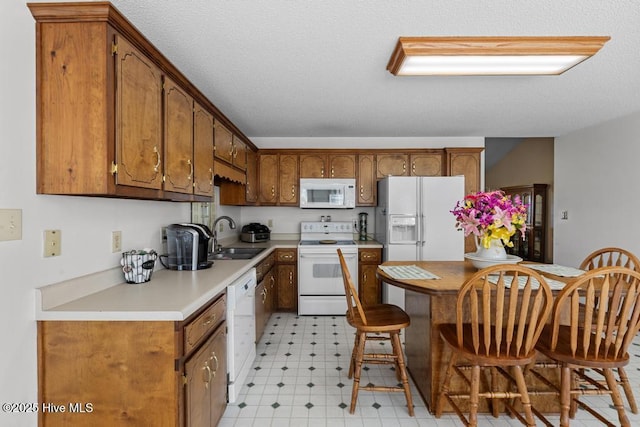 201 Cantle Ct, Jacksonville, NC 28540 - kitchen with light floors, white appliances, a sink, and brown cabinets