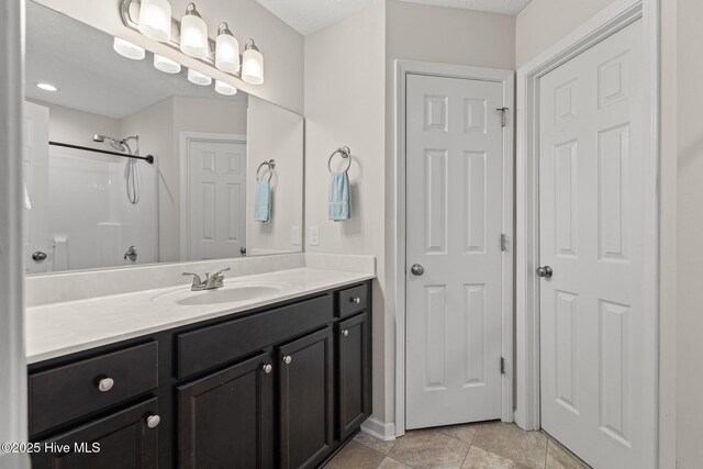 bathroom featuring vanity and a shower
