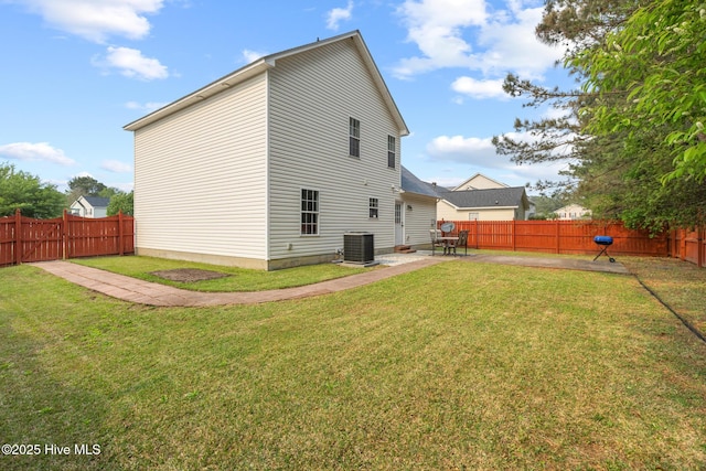 back of house featuring cooling unit, a yard, a fenced backyard, and a patio