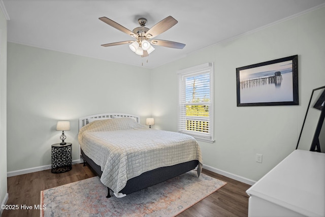 bedroom with a ceiling fan, ornamental molding, baseboards, and wood finished floors