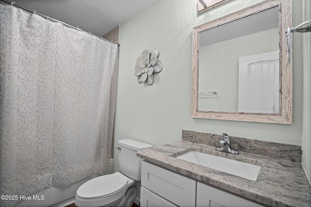 full bath featuring shower / bath combination with curtain, toilet, and vanity