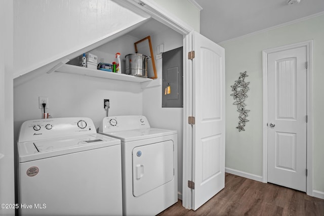 washroom with electric panel, crown molding, laundry area, independent washer and dryer, and dark wood-style flooring