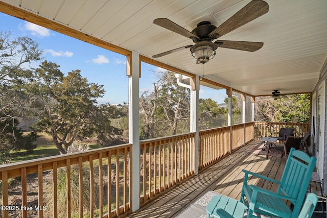 wooden deck with a ceiling fan