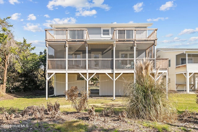 back of house featuring a balcony, a sunroom, and ceiling fan