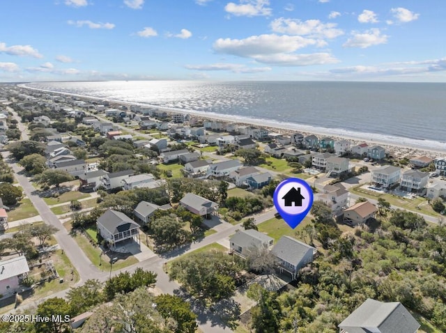 drone / aerial view with a beach view and a water view