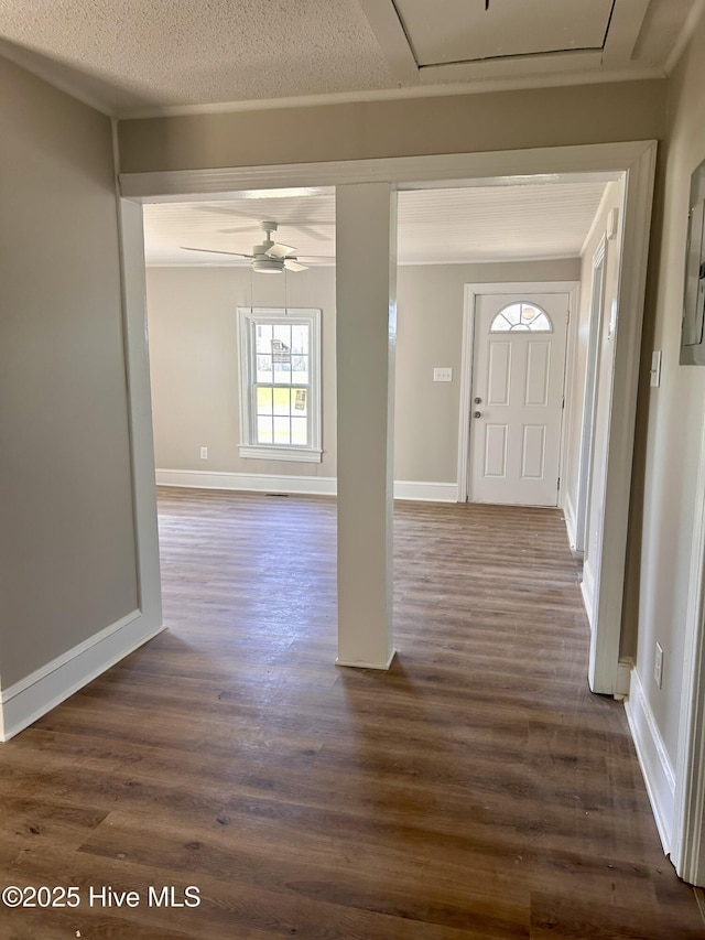 entrance foyer with dark wood-style flooring, baseboards, ceiling fan, and a textured ceiling
