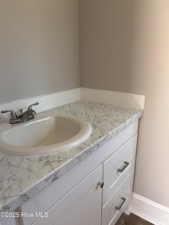 bathroom with vanity and baseboards