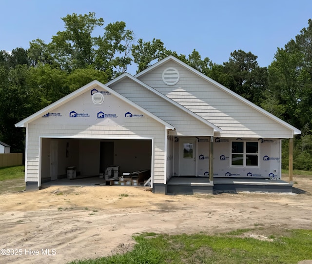 130 Buckskin Dr, Pollocksville, NC 28573 - unfinished property with driveway, a garage, and a porch