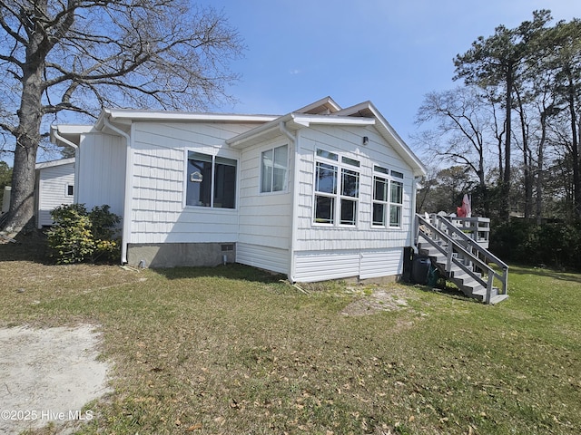 1229 Fletcher Hewett Rd SW, Shallotte, NC 28470 - view of home's exterior featuring stairs and a yard