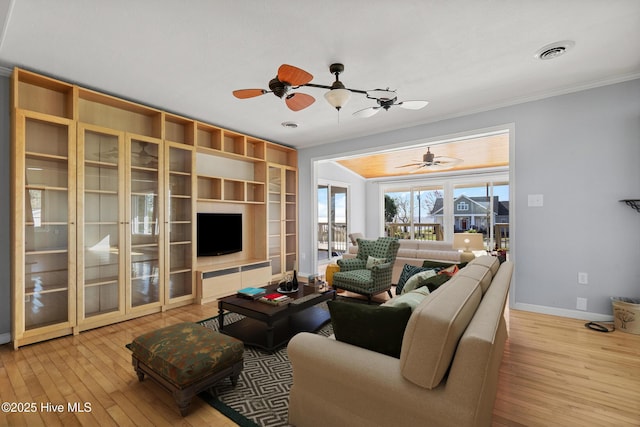 living room featuring visible vents, baseboards, ornamental molding, a ceiling fan, and hardwood / wood-style floors
