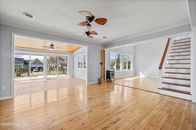 unfurnished living room featuring hardwood / wood-style floors, ornamental molding, visible vents, and a ceiling fan