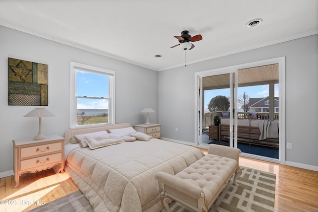 bedroom featuring access to exterior, wood finished floors, baseboards, visible vents, and ornamental molding