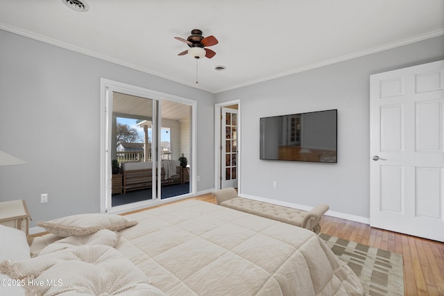 bedroom featuring wood-type flooring, ornamental molding, baseboards, access to outside, and visible vents