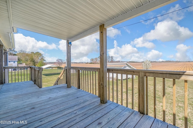 wooden deck featuring a yard