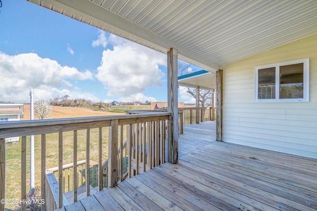 wooden deck with a lawn