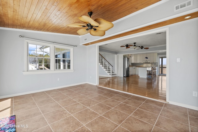 unfurnished living room with tile patterned flooring, crown molding, ceiling fan, and visible vents