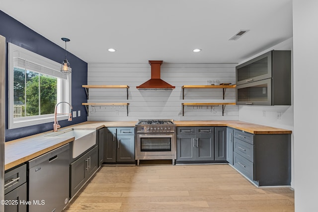 kitchen with visible vents, a sink, wood counters, open shelves, and stainless steel appliances