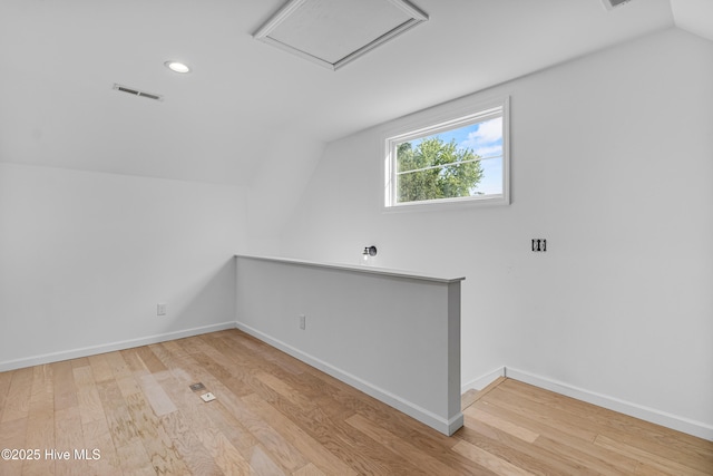 additional living space with lofted ceiling, recessed lighting, visible vents, and wood finished floors