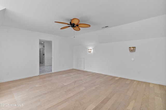 empty room featuring visible vents, light wood-style flooring, baseboards, and ceiling fan