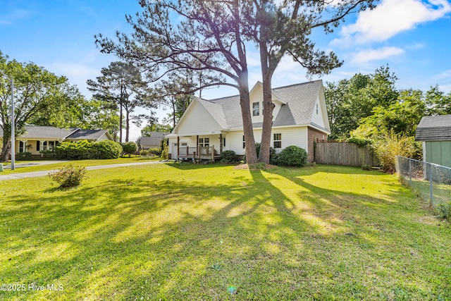 view of front facade with a front lawn and fence