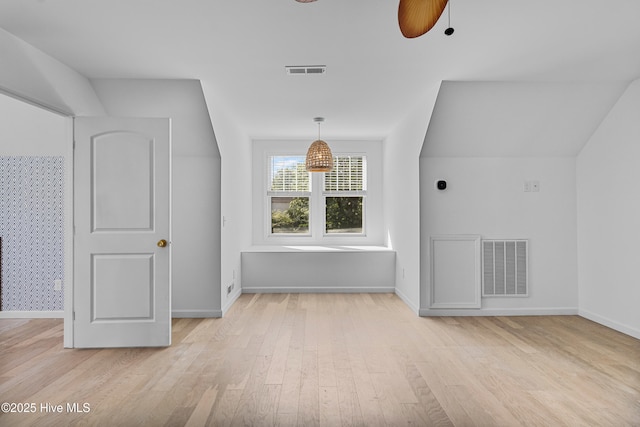 bonus room featuring light wood finished floors, visible vents, and baseboards