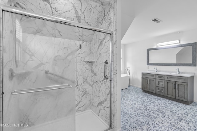 full bathroom with a soaking tub, double vanity, a marble finish shower, and a sink