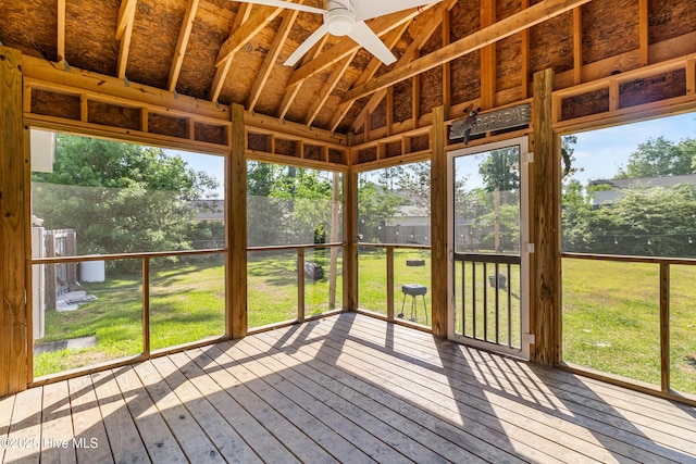 unfurnished sunroom featuring ceiling fan