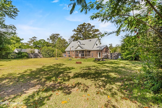 view of yard with a sunroom and a fenced backyard