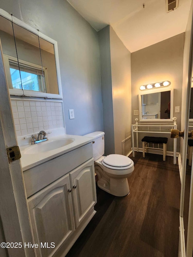 106 Hunters Trl E, Elizabeth City, NC 27909 - bathroom featuring toilet, vanity, tasteful backsplash, wood finished floors, and visible vents