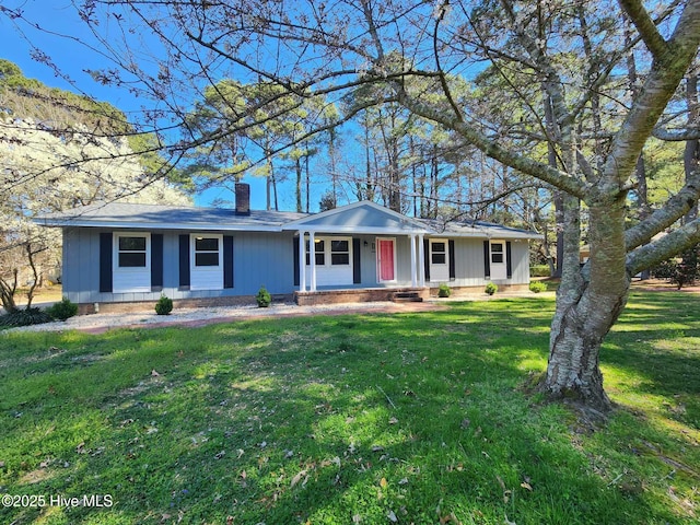 106 Hunters Trl E, Elizabeth City, NC 27909 - ranch-style house featuring a chimney, a porch, and a front lawn